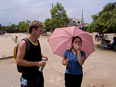 Matt contempates the details of a Lao Wedding, Sekong, Laos