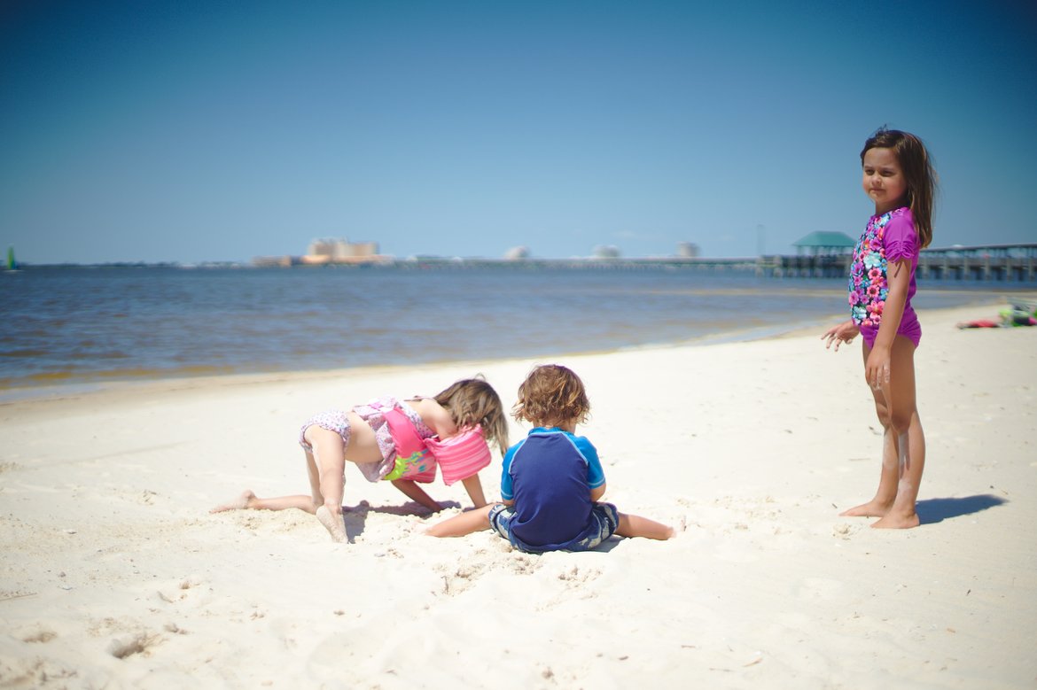 kids playing on the beach, ocean springs, ms photographed by Scott Gilbertson