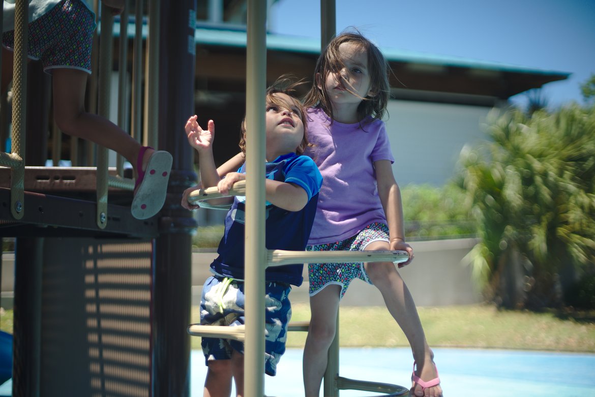 kids playing on playground, ocean springs, ms photographed by luxagraf