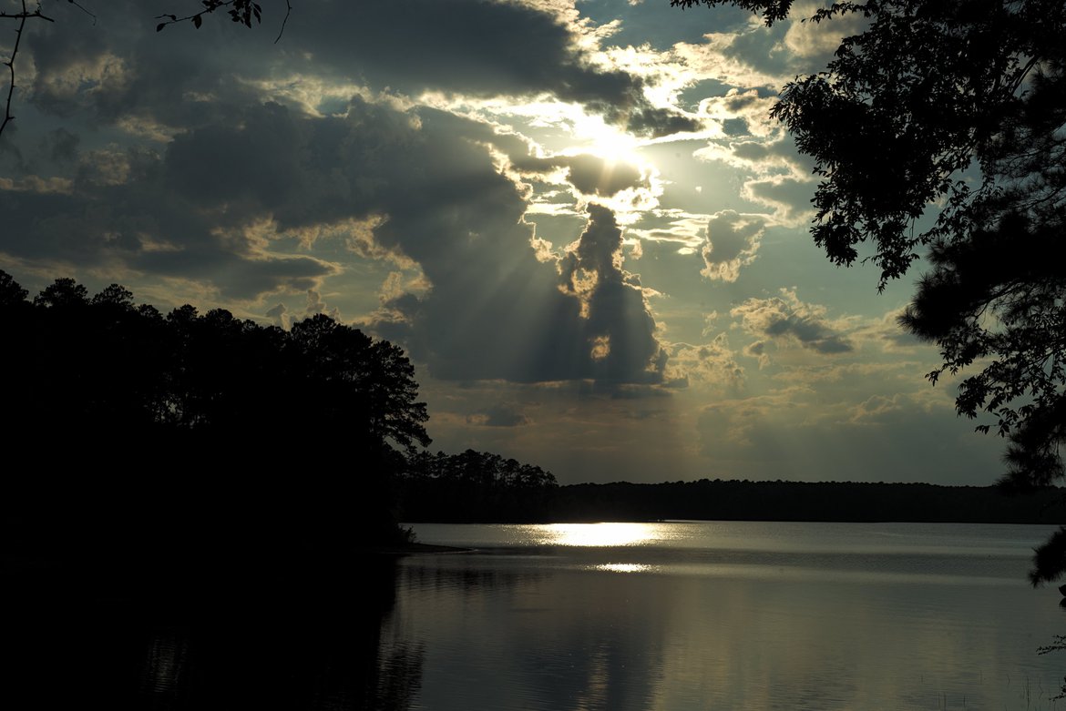 clouds and sunbeams over lake, raysville GA photographed by luxagraf