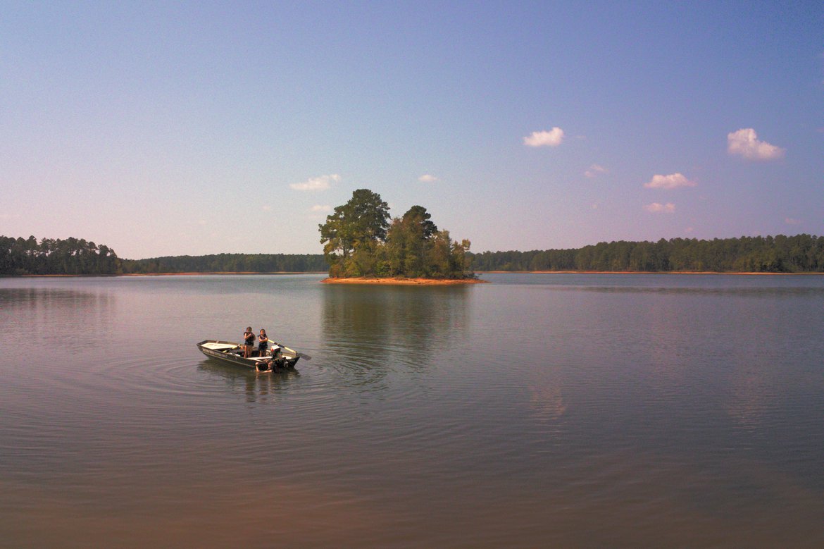 drone image of boat and swimmers on lake, raysville ga photographed by luxagraf