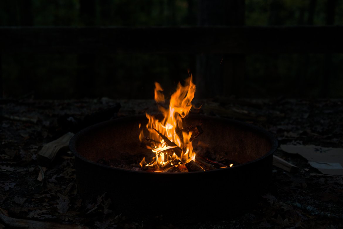 orange flames of campfire in the night photographed by luxagraf