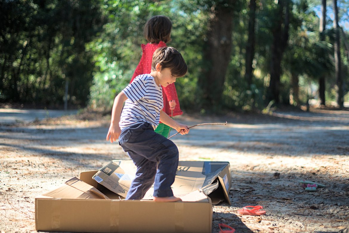 playing with a cardboard box (they made it a raft) photographed by luxagraf