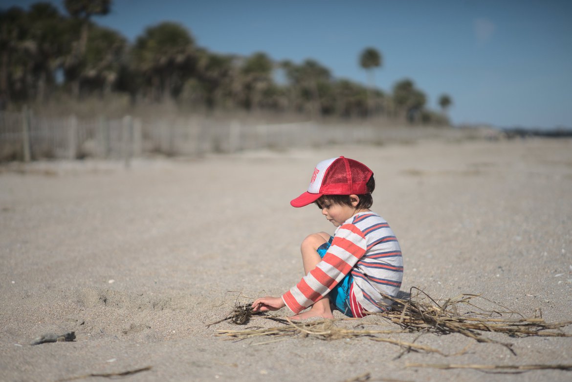 boy playing in the sand, edisto state beach, sc photographed by luxagraf
