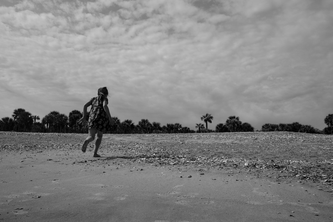 girl running on the beach, edisto state beach, sc photographed by luxagraf