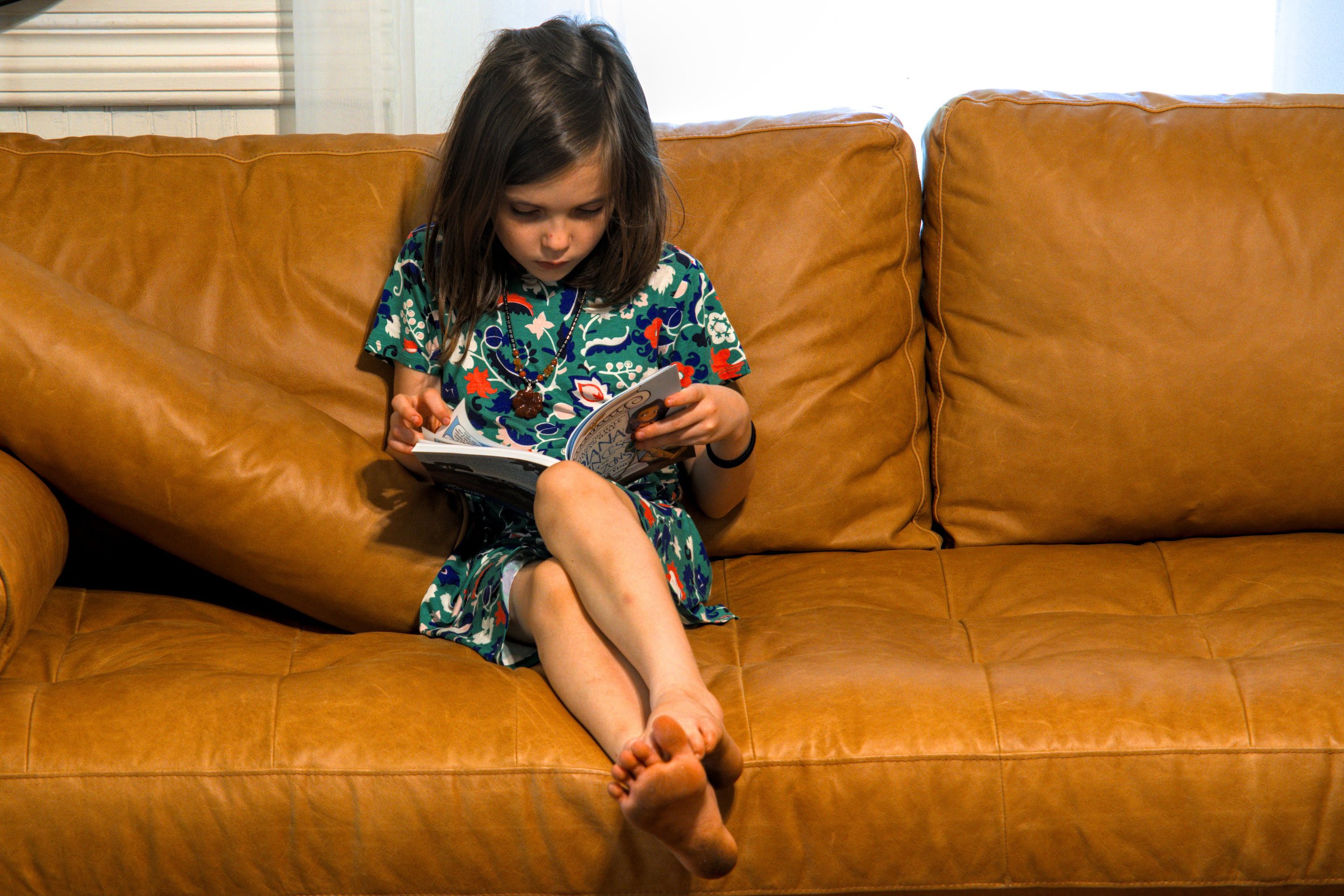 girl reading on a couch photographed by luxagraf