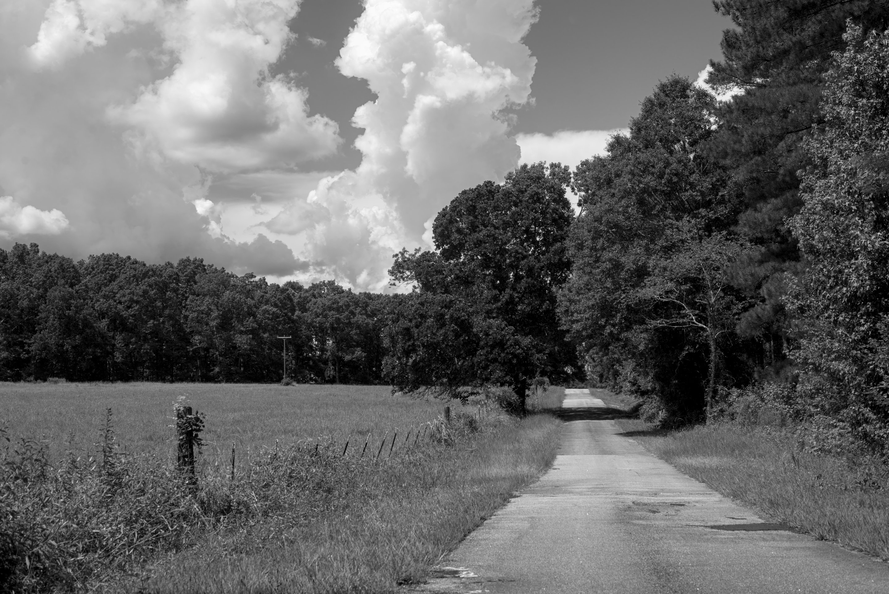 clouds over a field, black and white photographed by luxagraf