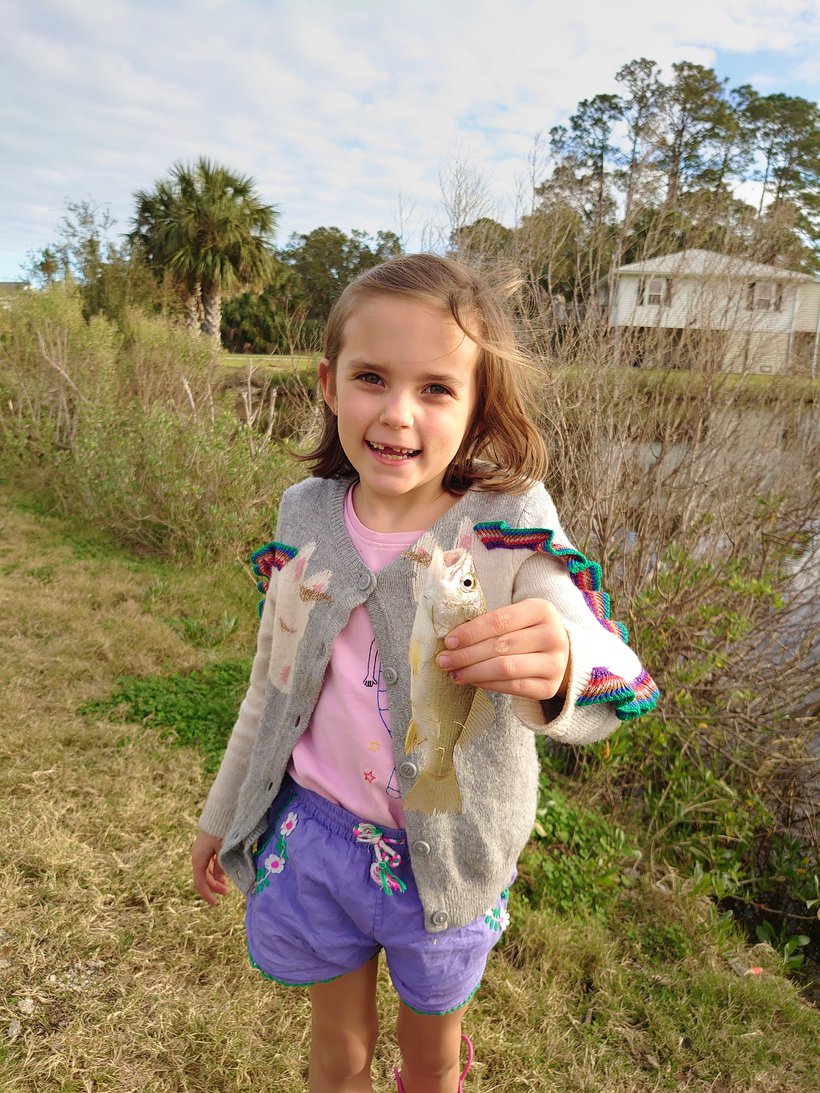 girl hold a fish she caught photographed by luxagraf