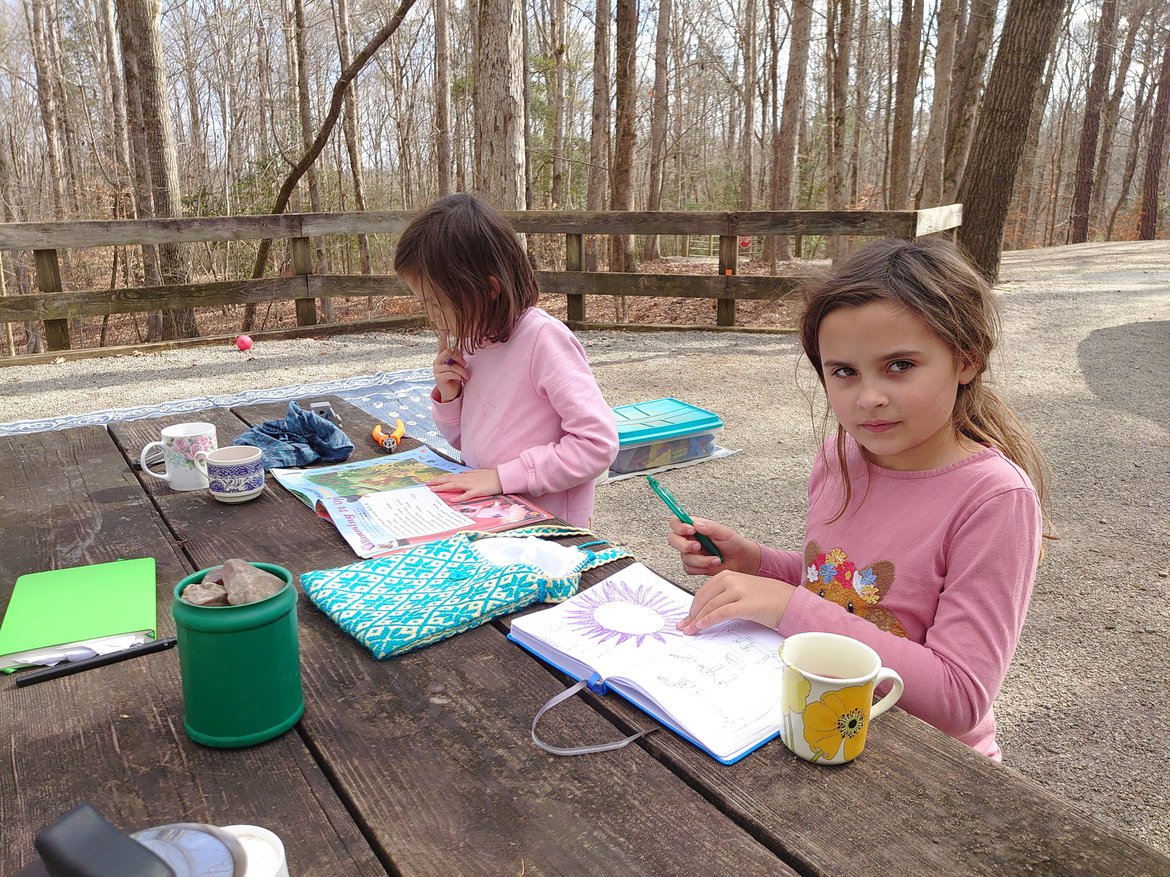 Girls at table with notebooks, Homeschooling photographed by luxagraf