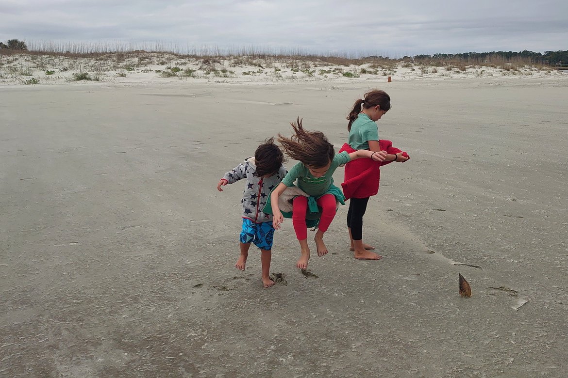 kids running on the beach, hunting island state beach photographed by luxagraf
