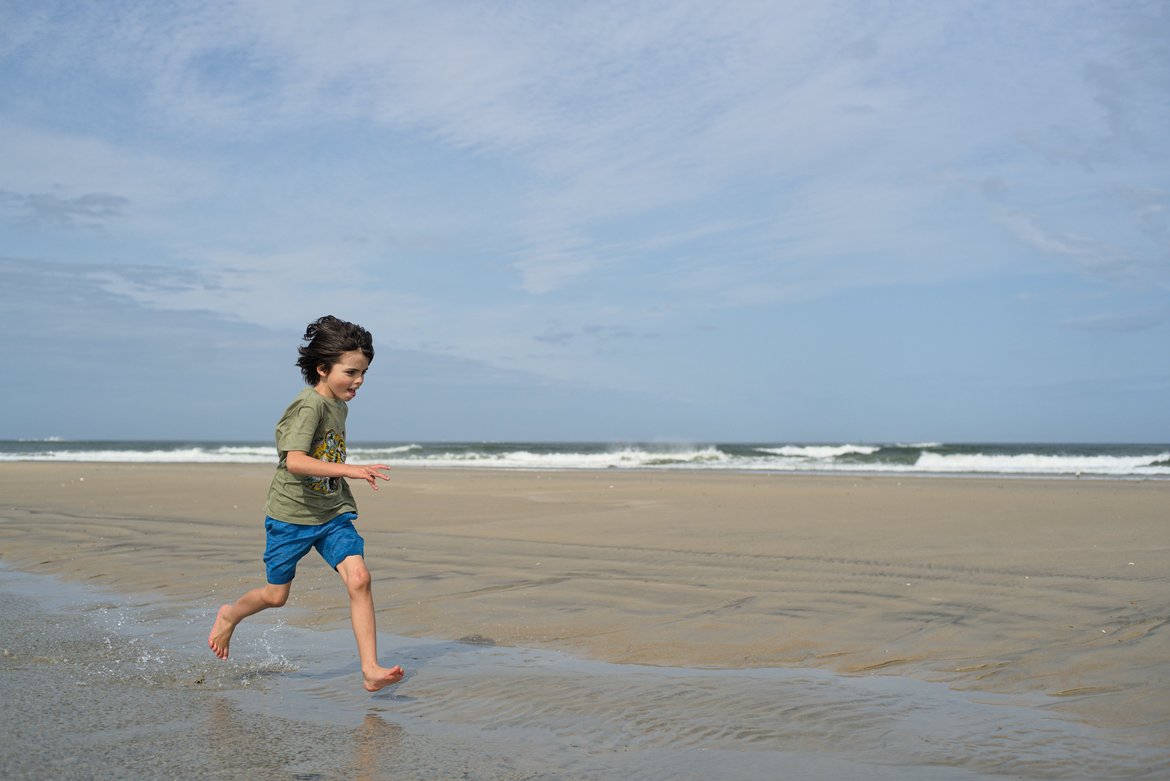 boy running on the beach, oregon inlet, north carolina photographed by luxagraf