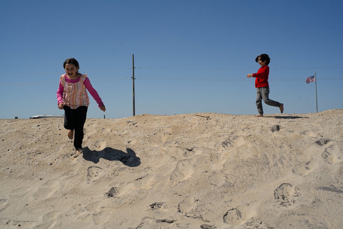 kids playing on the dunes, pea island, nc photographed by luxagraf