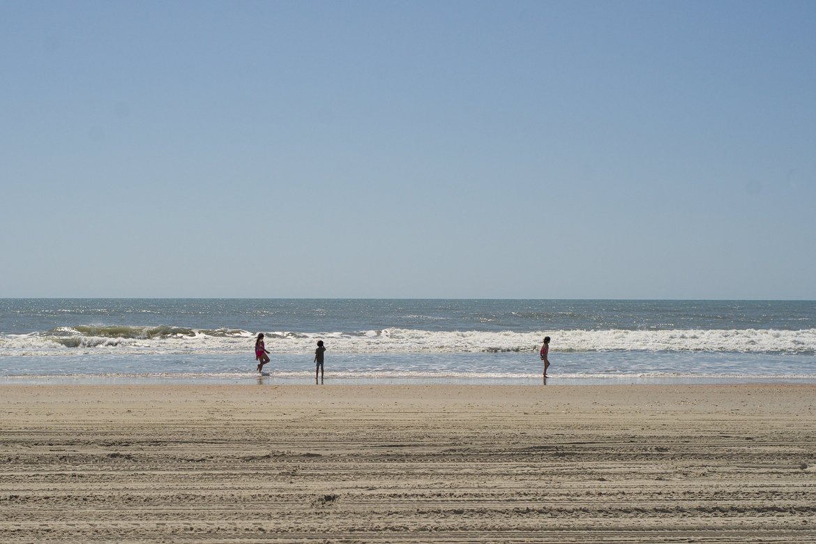 kids playing in the surf, hatteras island, nc photographed by luxagraf