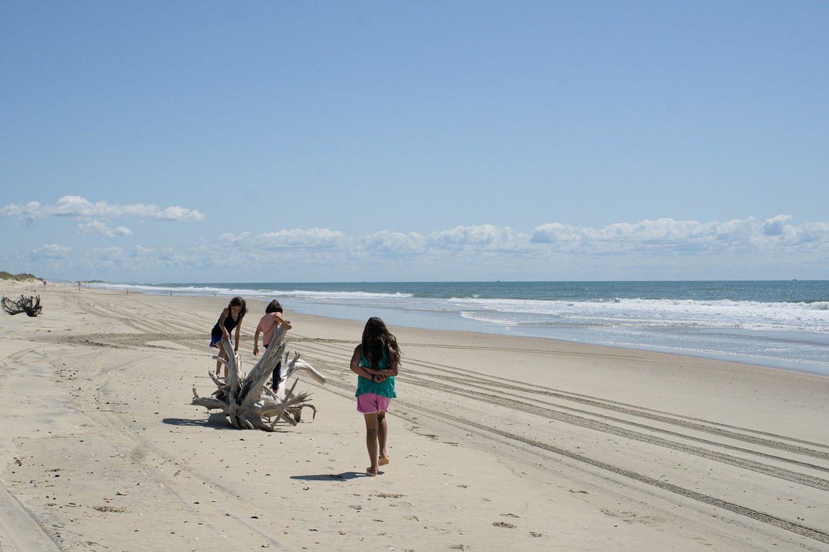 kids playing on the beach, ocracoke, NC photographed by luxagraf