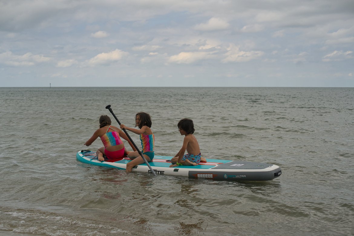 kids playing on a paddleboard, springers point, ocracoke, NC photographed by luxagraf