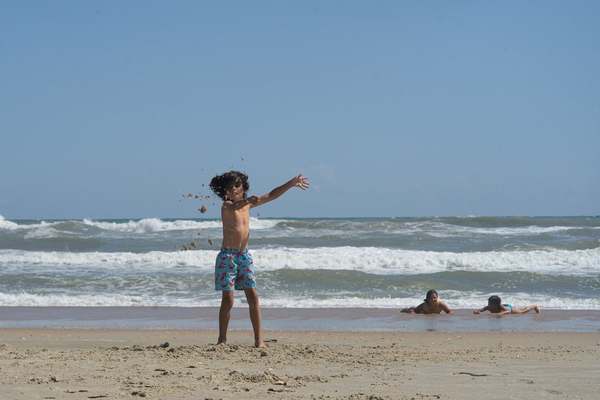 kids playing on the beach, hatteras island, nc photographed by luxagraf