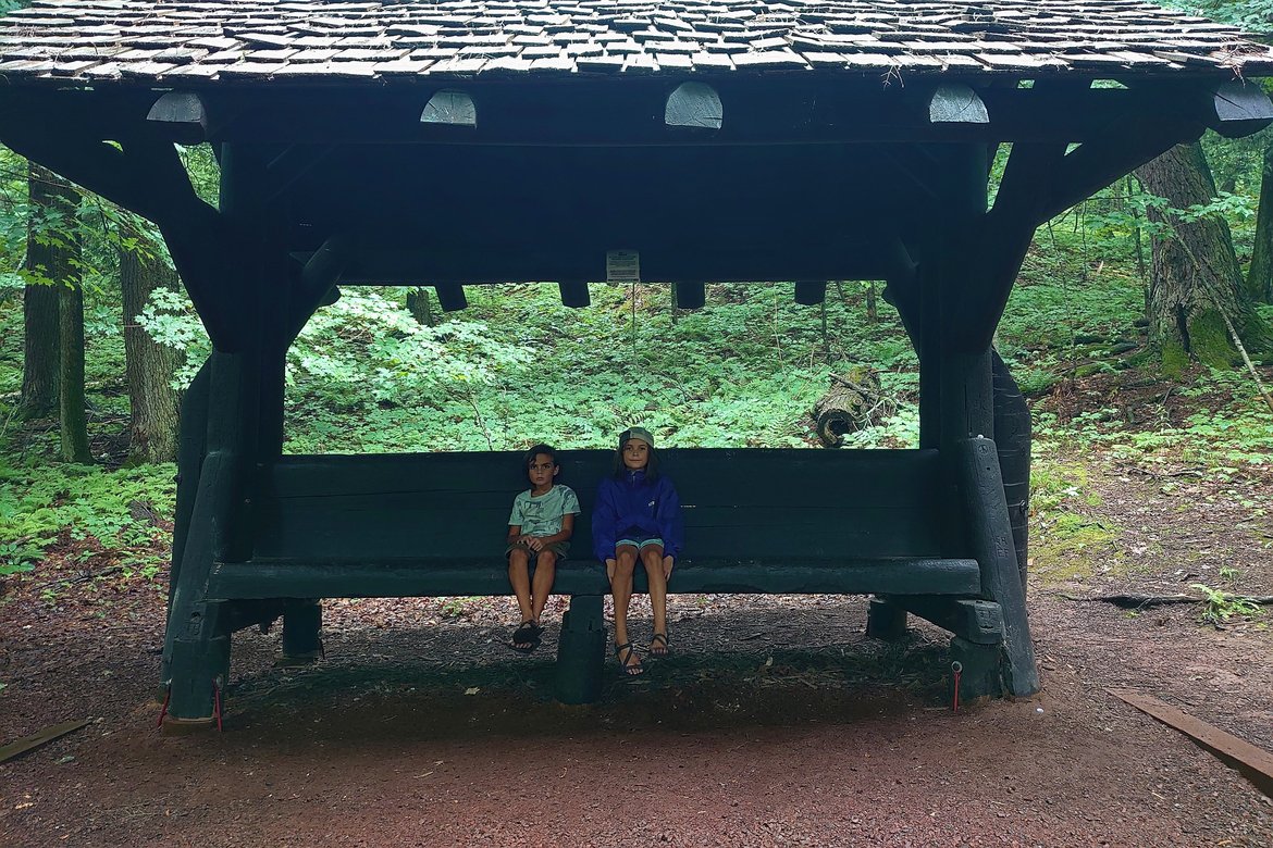 kids sitting on a bench alongside the trail photographed by luxagraf