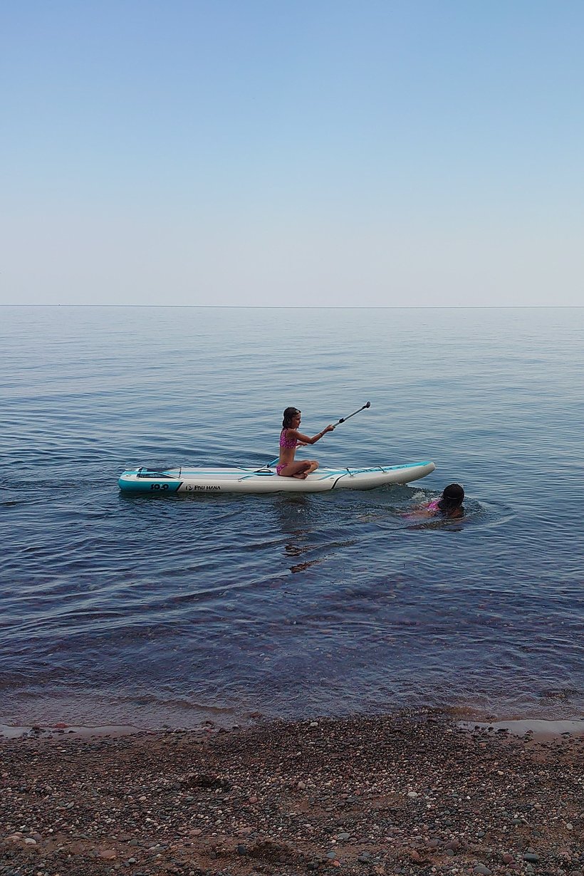kids playing on a paddleboard, little girl point, WI photographed by luxagraf