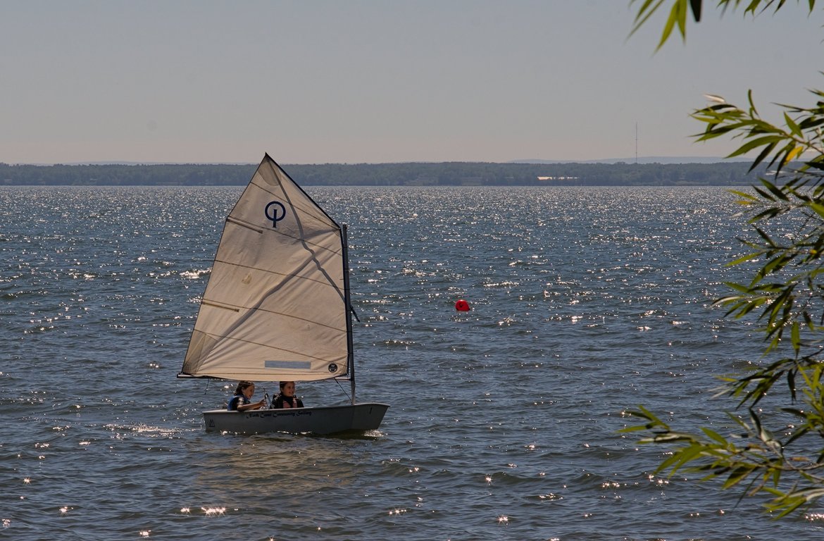 Kids sailing in an optimist dinghy. photographed by luxagraf