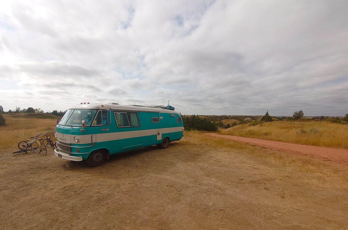 the big blue bus on a bluff in the little missouri grasslands photographed by luxagraf