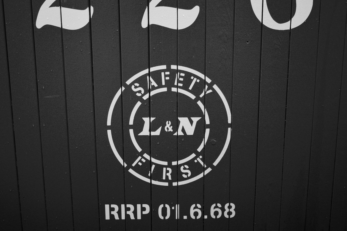 Safety first sign on side of train car photographed by luxagraf