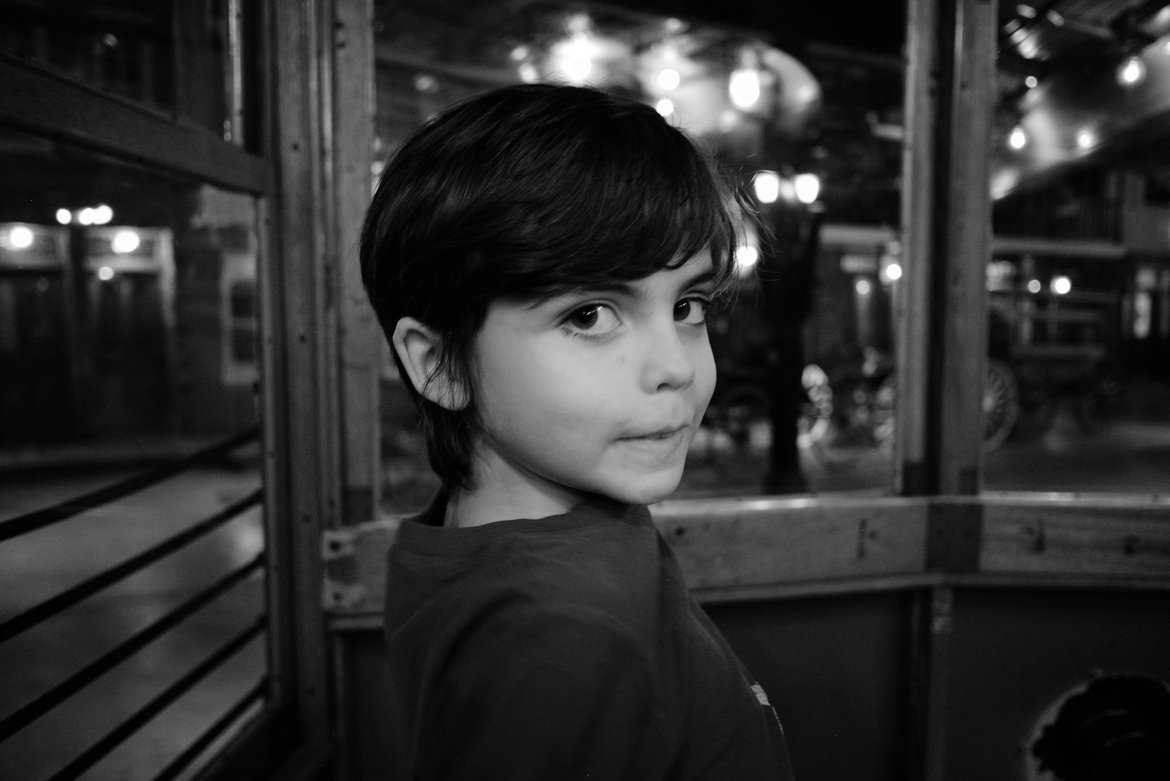 portrait of a boy in an old street car, historic pensacola village, pensacola, fl photographed by luxagraf