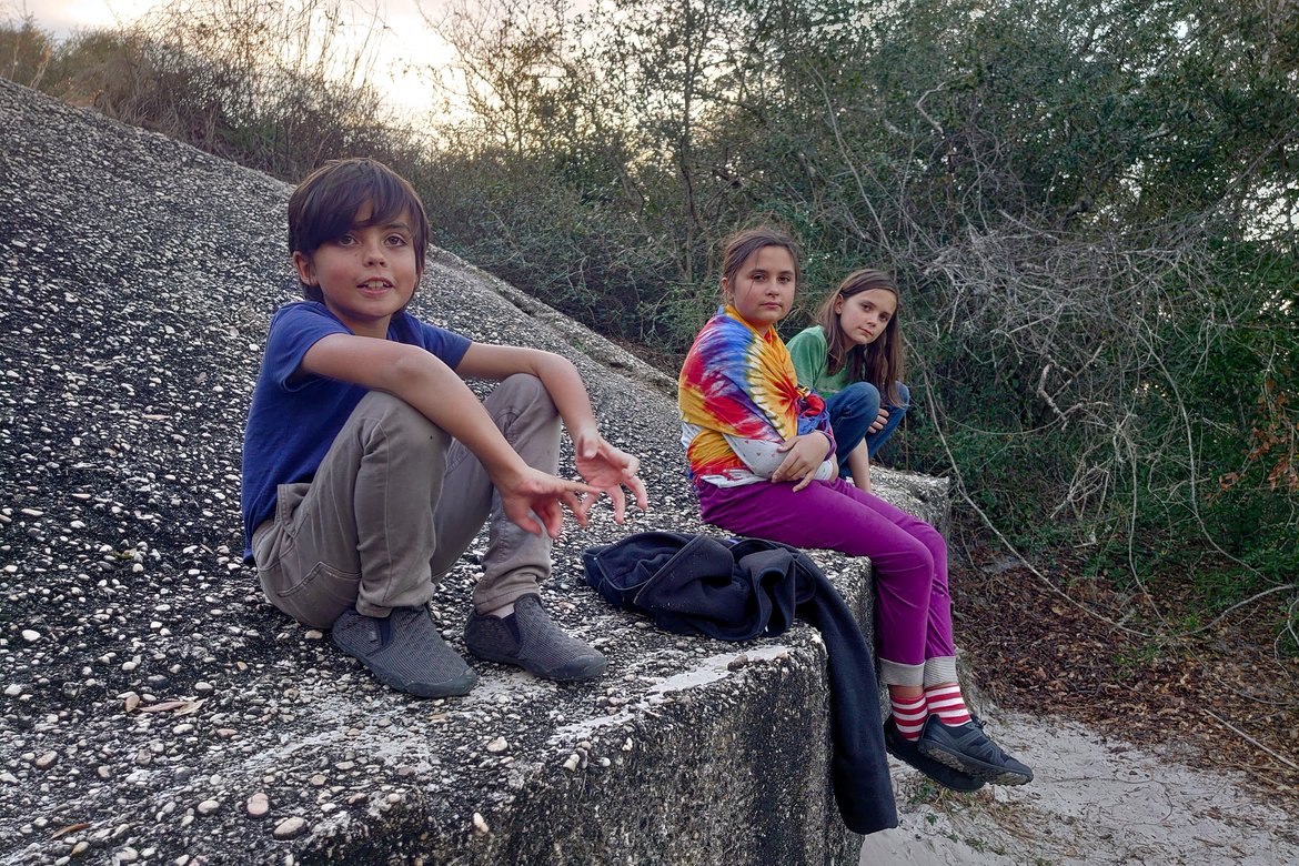 kids sitting on the wall of a battery, fort pickens, FL photographed by luxagraf