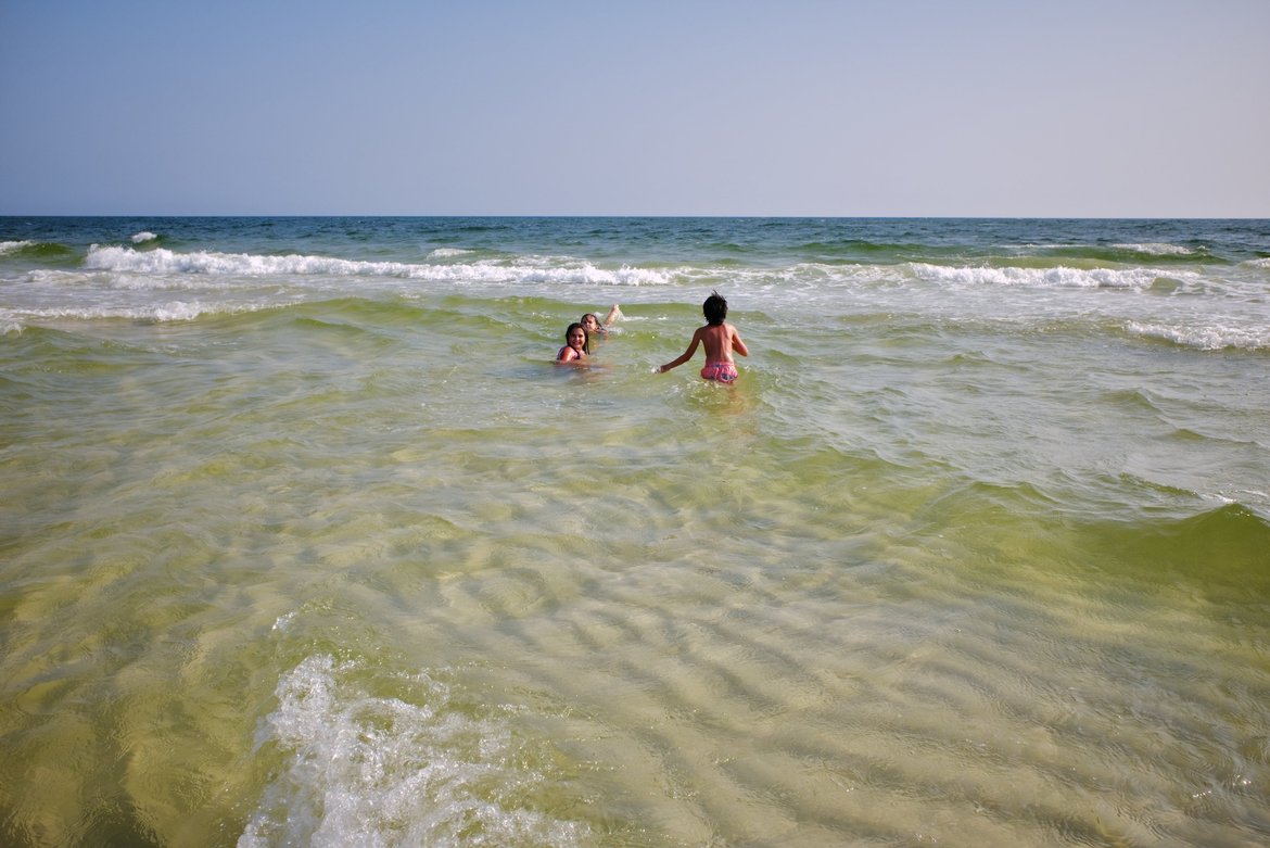 kids playing in the surf, fort pickens, FL photographed by luxagraf