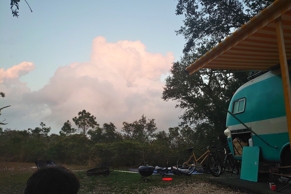 bus in campsite, clouds in the distance photographed by luxagraf
