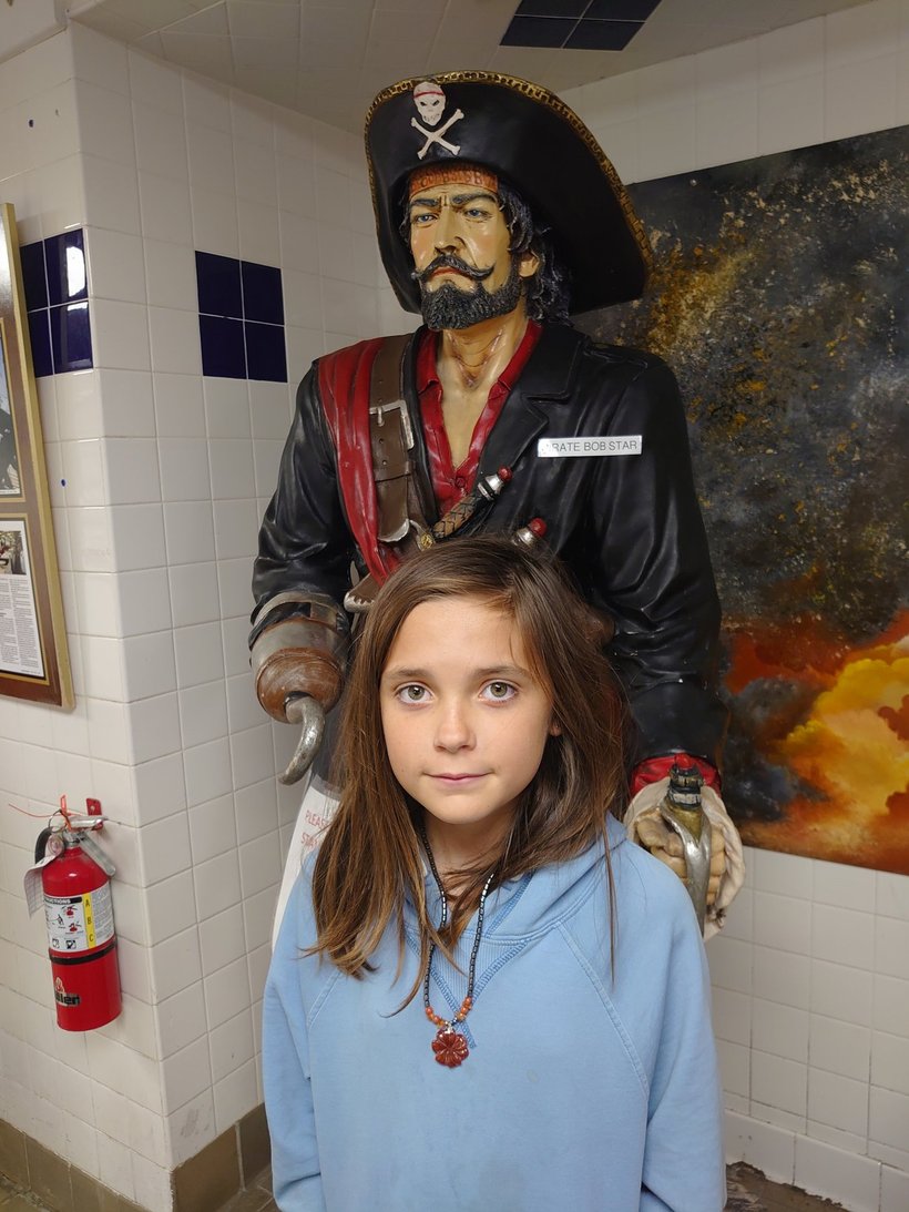 girl by a pirate statue at Joe Patti's photographed by luxagraf