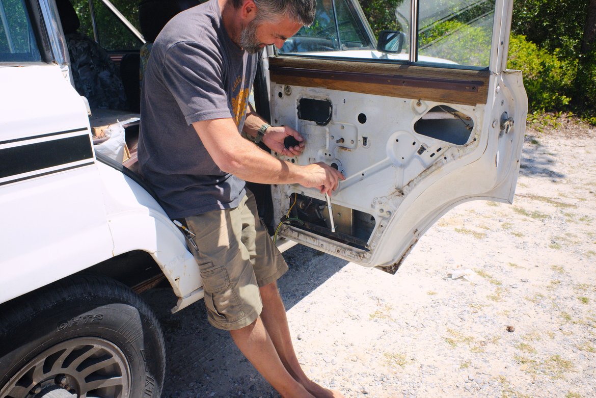 me fixing taking apart the door of the jeep wagoneer photographed by luxagraf