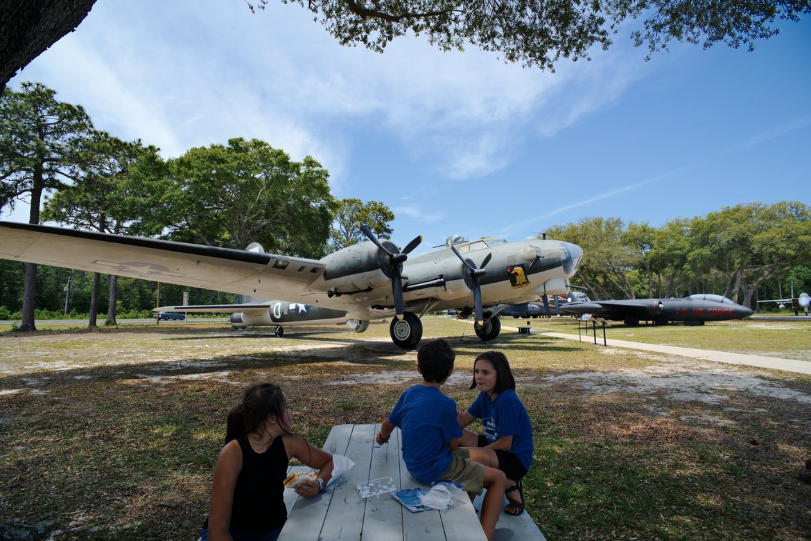 eating lunch in the shade of WWII bombers photographed by luxagraf