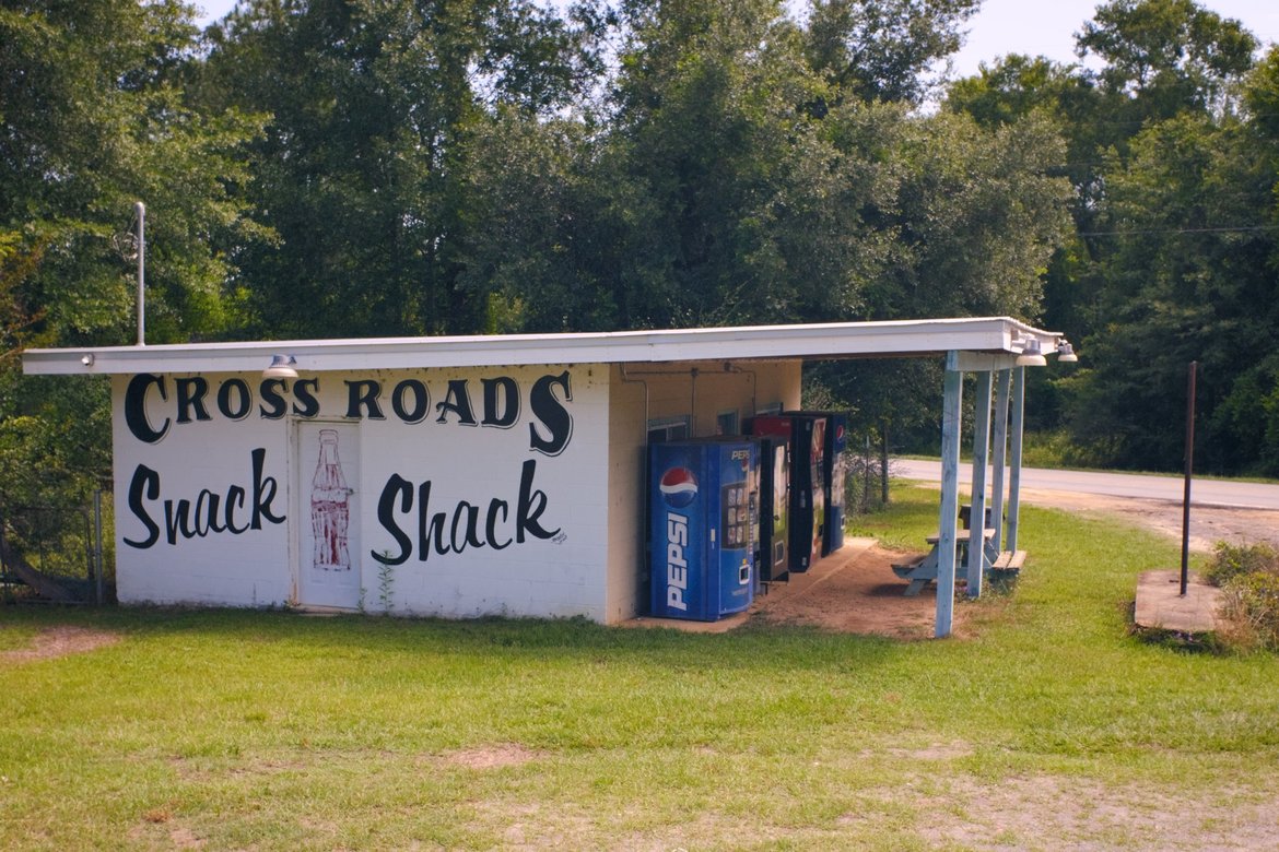 rundown building named the cross roads snack shack photographed by luxagraf