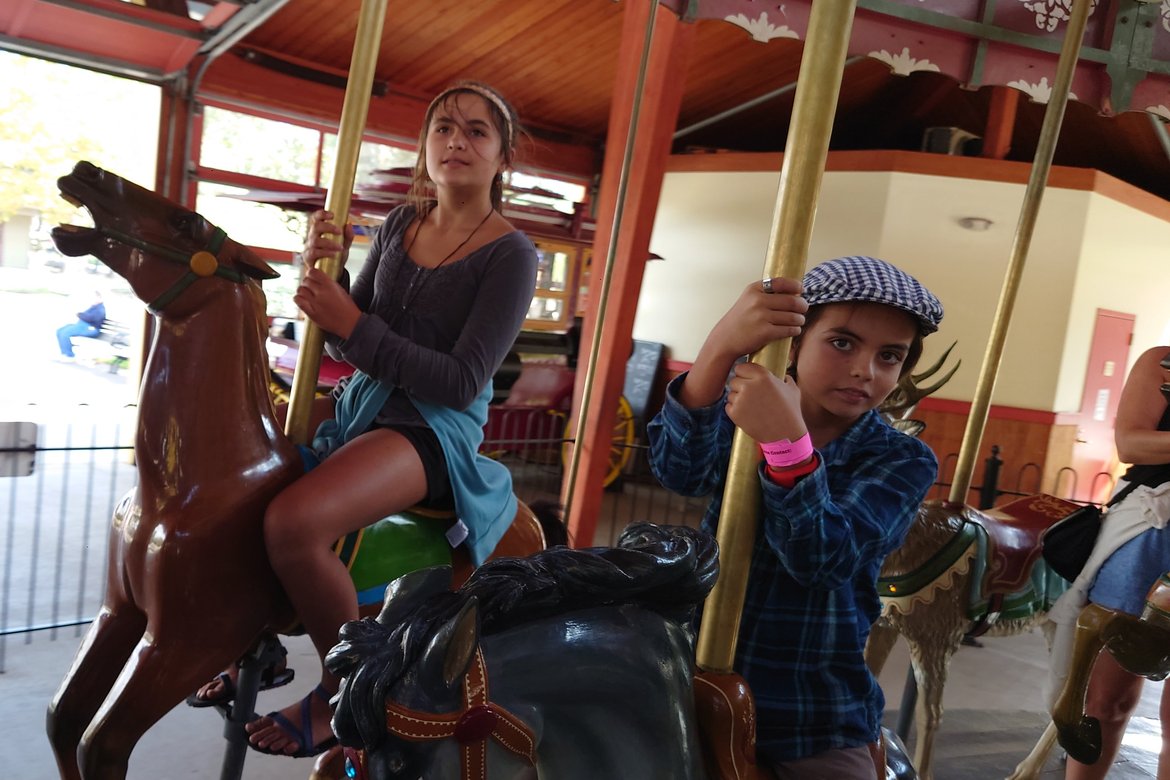 kids riding carousel horses, greenfield village photographed by luxagraf