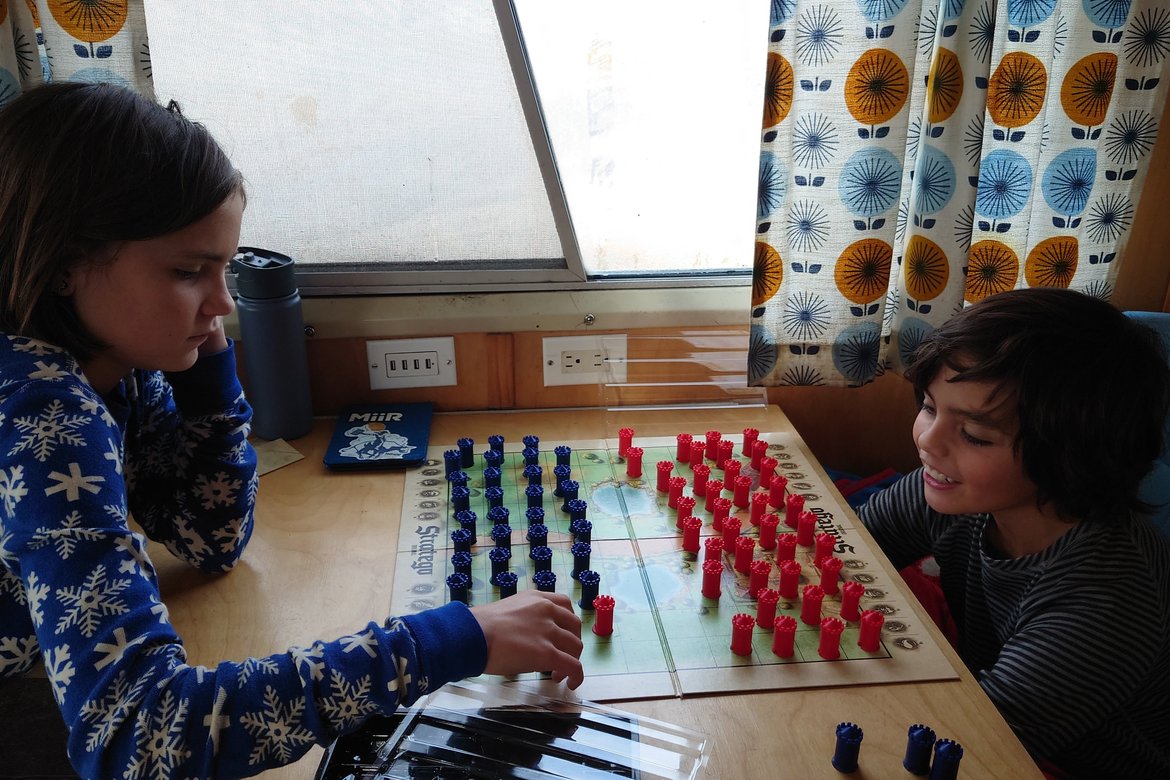 kids playing stratego in the bus photographed by luxagraf