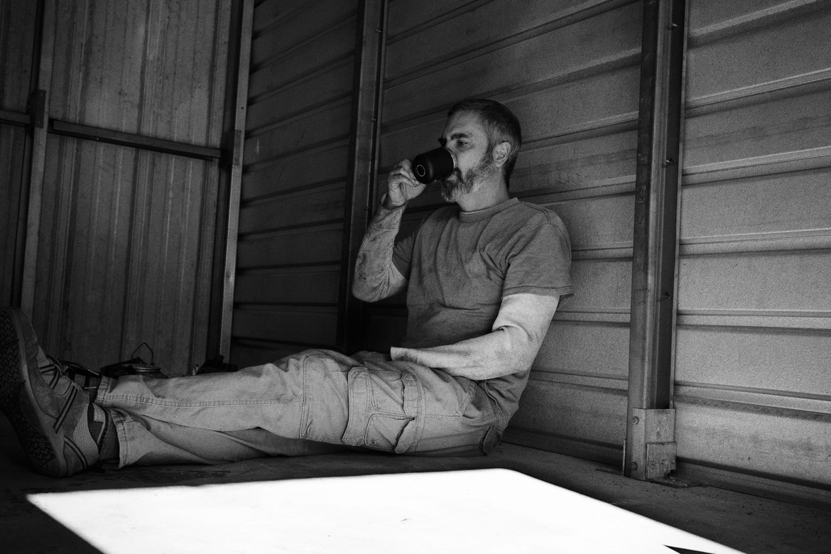 me drinking coffee in the storage unit where I tried to fix the jeep photographed by luxagraf