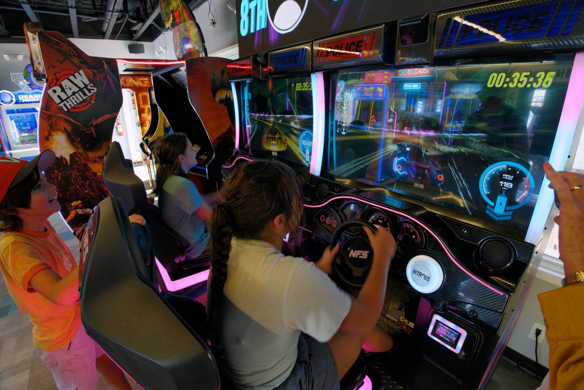 girls playing driving game, arcade, balboa fun zone photographed by Scott Gilbertson