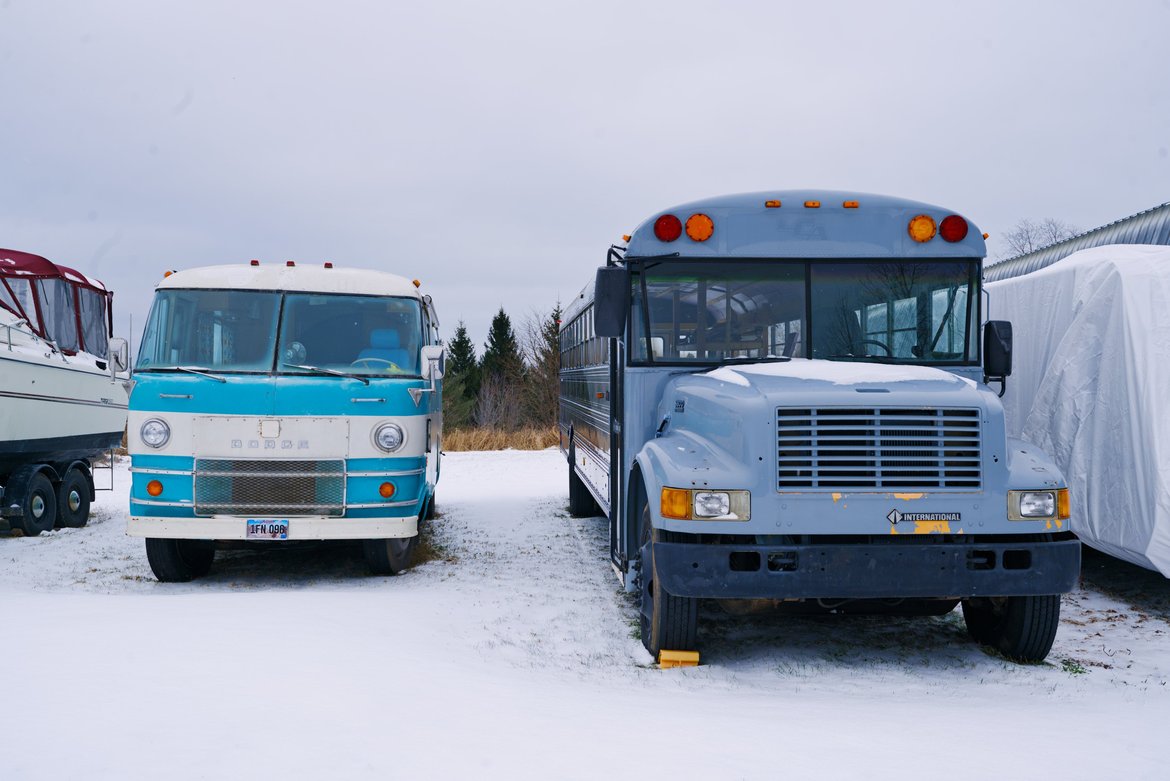 two buses side by side in storage photographed by Scott Gilbertson