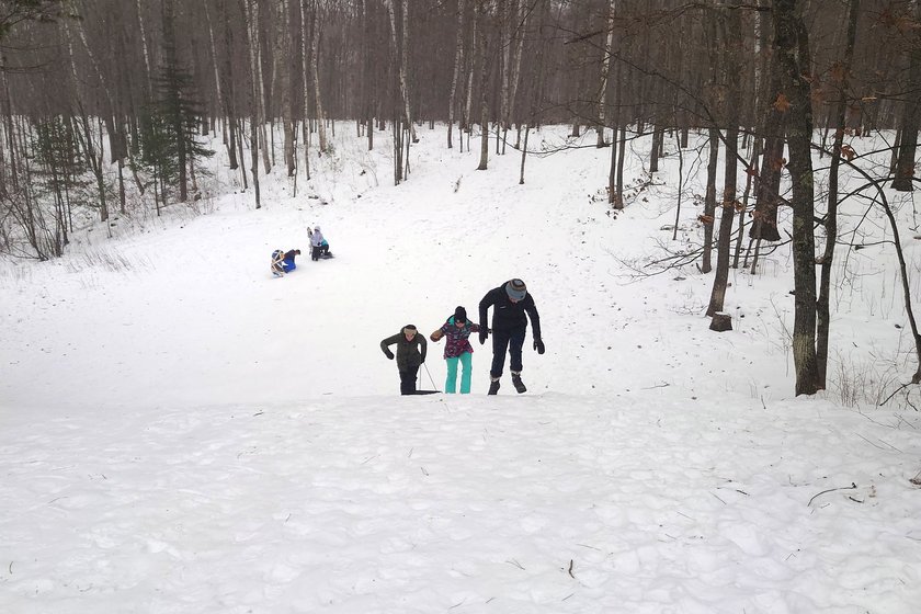 children walking uphill in the snow by Scott Gilbertson