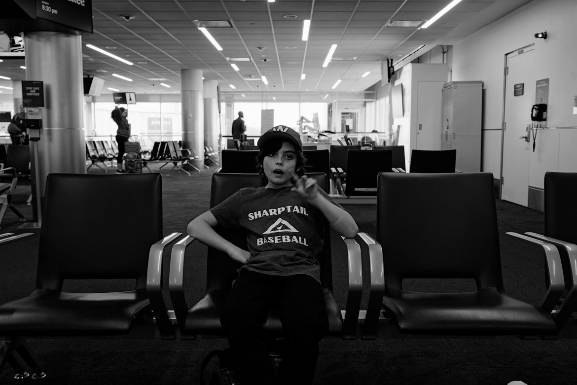 boy waiting in the minneapolis airport photographed by Scott Gilbertson