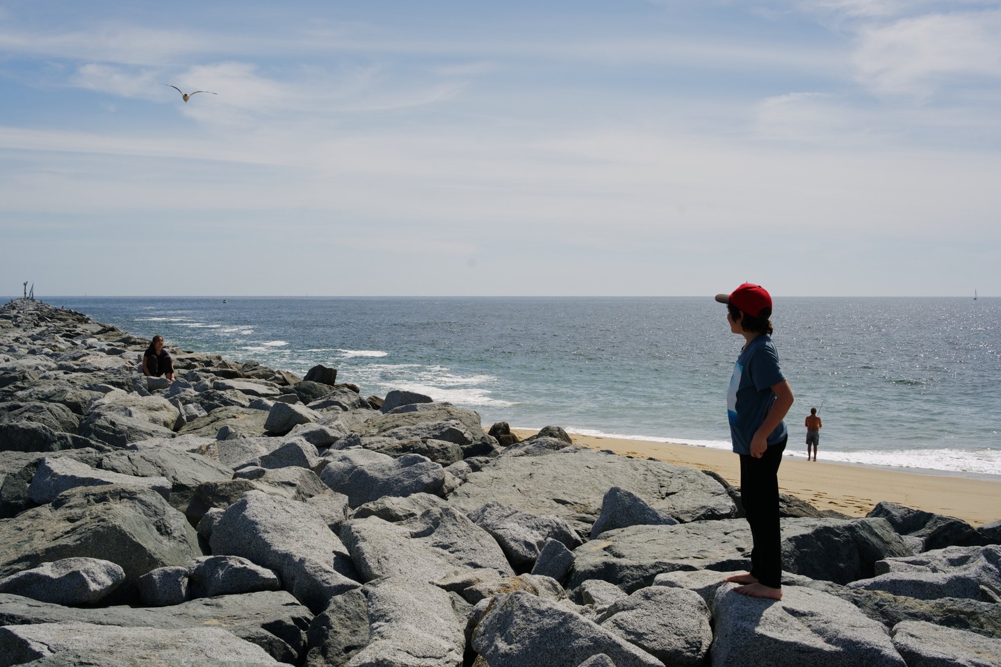 boy standing on the jetty, the wedge, balboa peninsula by Scott Gilbertson