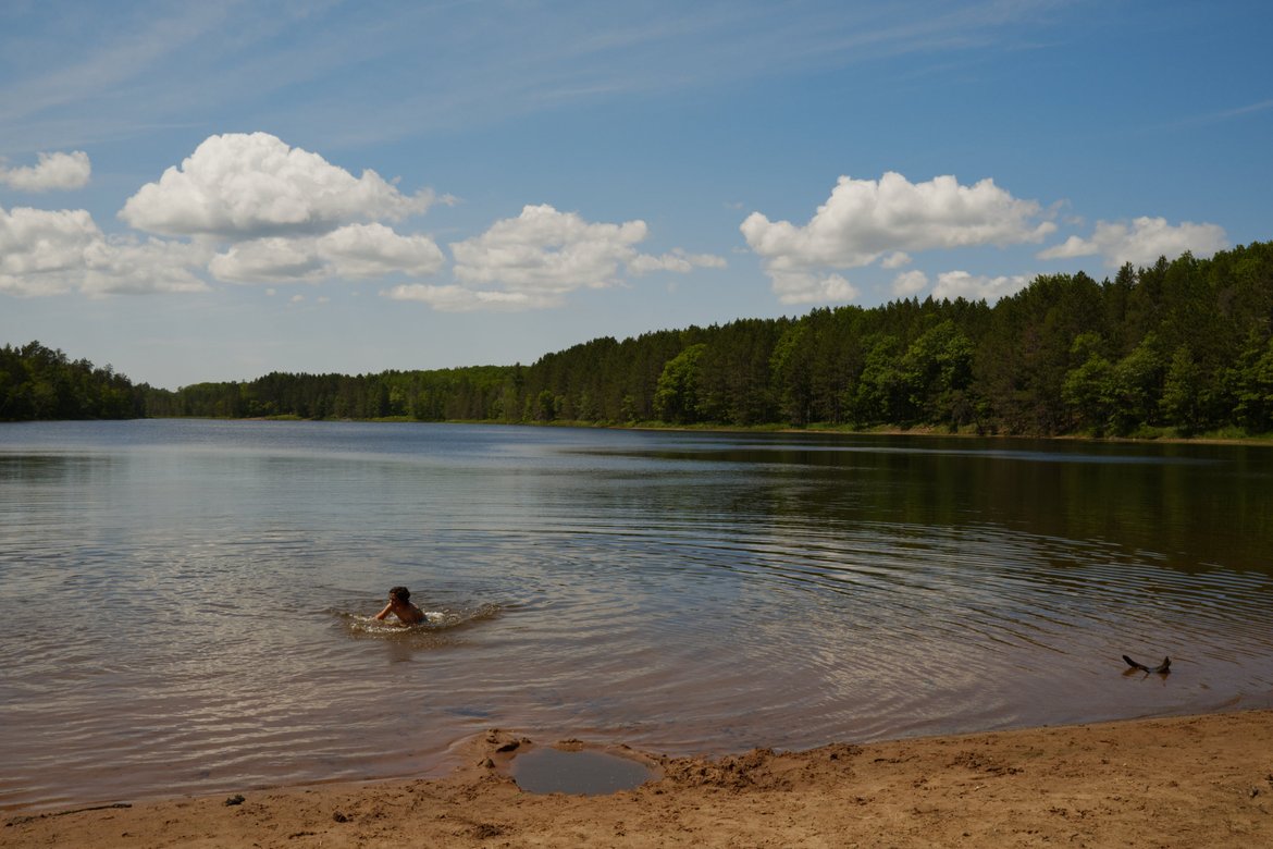 swimming in long lake mid ride photographed by Scott Gilbertson