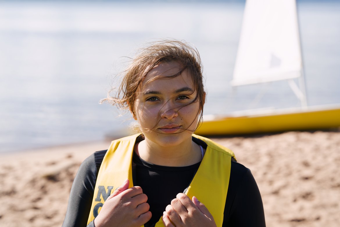 girl in a life jacket in front of a boat photographed by Scott Gilbertson